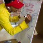 Student adding core value to flip chart