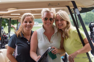 3 women with golf cart